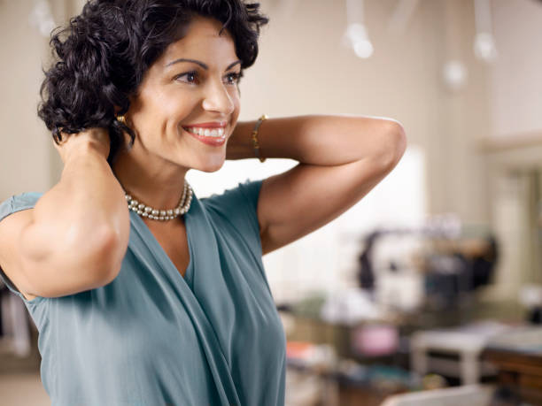 Female customer trying on pearl necklace in shop  short sleeved stock pictures, royalty-free photos & images