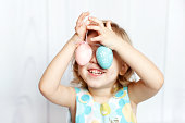 Happy cute little girl holding Easter eggs