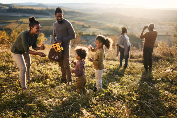 Happy black multi-generation family having fun on a hill.