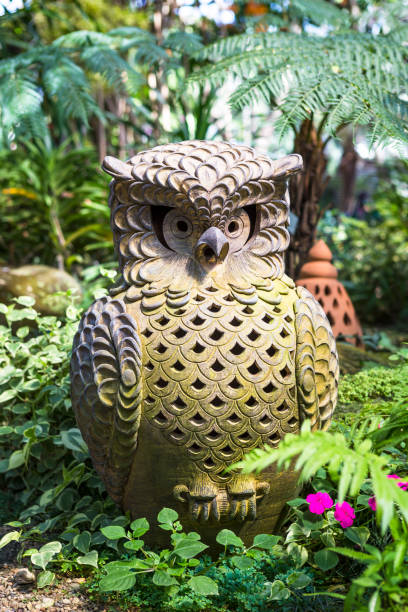 istock Design owl terracotta in tropical garden 2004539711