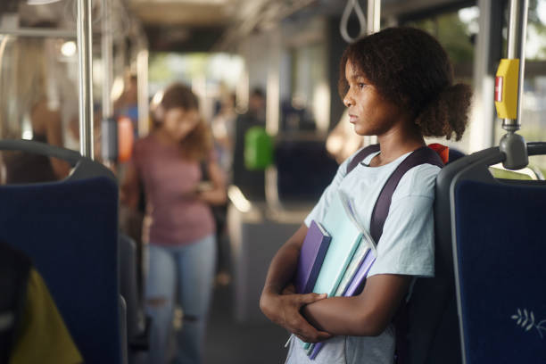 Black schoolgirl traveling by public transport.
