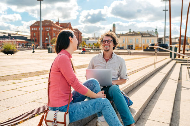 istock Two Students Discussing Their Class Notes On A Laptop On The Quayside In Malmo In Sweden 2004565452