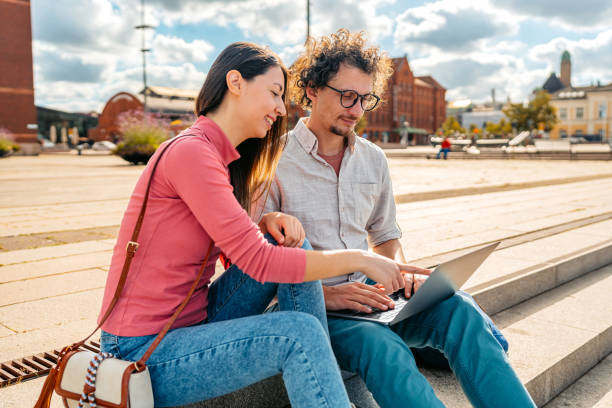 istock Two Students Discussing Their Class Notes On A Laptop On The Quayside In Malmo In Sweden 2004568671