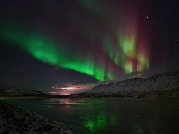 istock Northern light Aurora Borealis above snowcapped mountains in Iceland. 2004569732