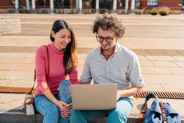 istock Two Students Discussing Their Class Notes On A Laptop On The Quayside In Malmo In Sweden 2004571317