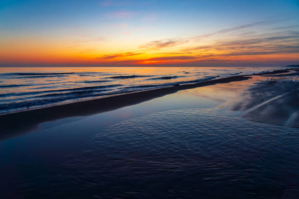 istock Brightly colorful sunrise on the sea coast 2004608917