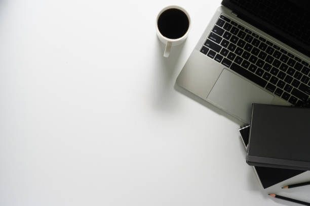 istock Office desk with laptop computer, coffee cup and notebooks. Top view with copy space 2004609992