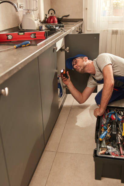 istock Plumber fixing and repairing water pipes under the kitchen sink. 2004618735