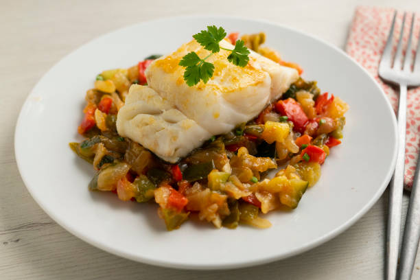 Cod tapa cooked with vegetables in samfaina. Traditional recipe of Spanish gastronomy..