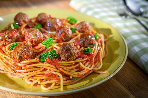 Close-up of meatballs with noodles serve in plate on table.