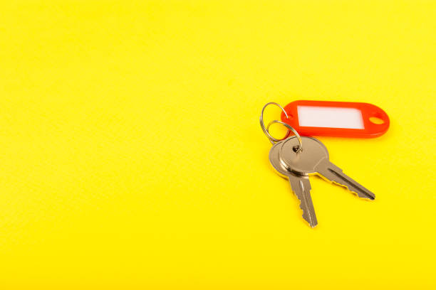 istock Plastic key ring in different colors with a place for a signature on a bright colored background. Bunch of keys with keychain. Mock-up keychain.Copy space.Concept for renting and selling real estate. 2004663096