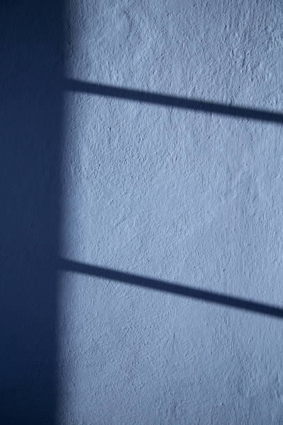 istock background of blue wall with shadow and sunlight 2004666902