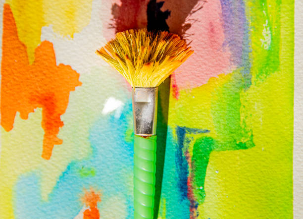 istock Colorful watercolor background, paintbrush and paint can on abstract 2004667947