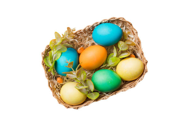 Basket of colorful Easter eggs isolated on white background. Easter basket filled with colored eggs top view holiday concept .