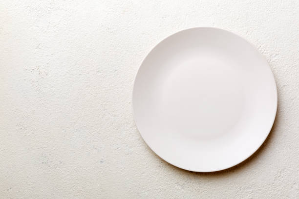 istock Top view of empty light plate on cement background. Empty space for your design 2004684062