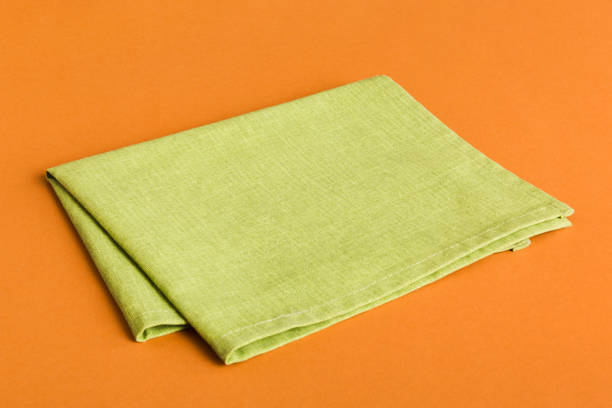 istock top view with green kitchen napkin isolated on table background. Folded cloth for mockup with copy space, Flat lay. Minimal style 2004685148