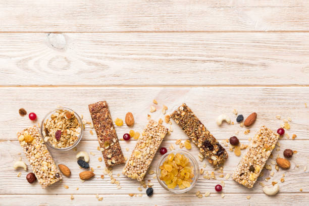 istock Various granola bars on table background. Cereal granola bars. Superfood breakfast bars with oats, nuts and berries, close up. Superfood concept 2004685196