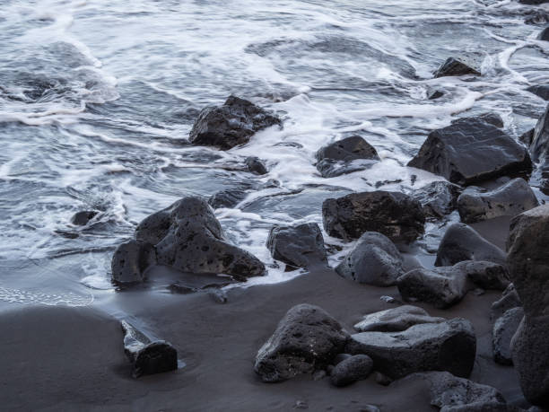 istock beach with black volcanic sand on  Tenerife 2004690534
