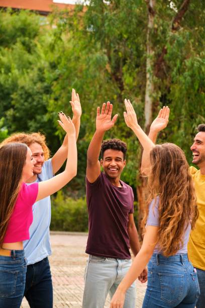 istock Cheerful multiethnic friends laugh out loud and give each other high five. 2004701562