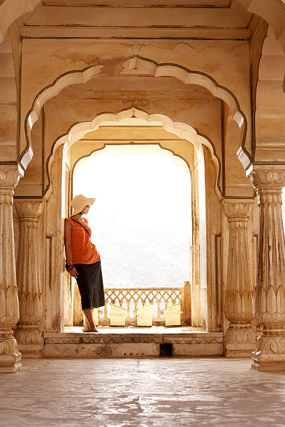 India, Rajasthan, Amber Fort, woman standing on palace balcony  amber fort stock pictures, royalty-free photos & images
