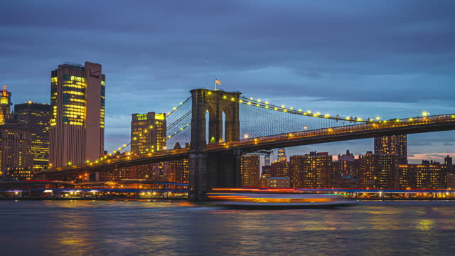 4K Footage Time Lapse of New York cityscape riverside with Brooklyn Bridge over the East River at sunset time in Manhattan, New York City, United States, USA, Travel Destination tourist