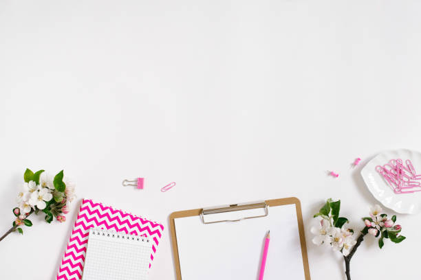 istock Stylish flat lay women's workplace with notebooks, tablet, pen and spring apple blossoms on a white background with copy space 2004767251