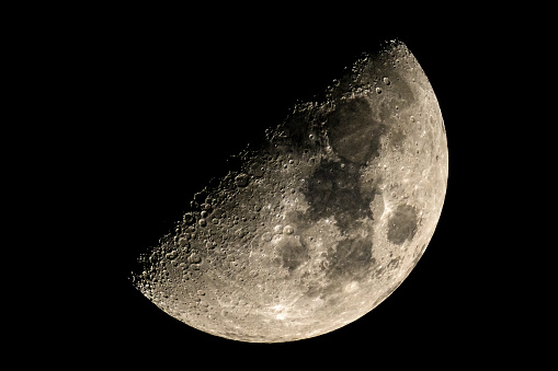 Full moon over the dark black sky at night. High resolution image shot in 2015.