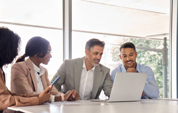 istock Diverse business team people using laptop at office work meeting. 2004777399
