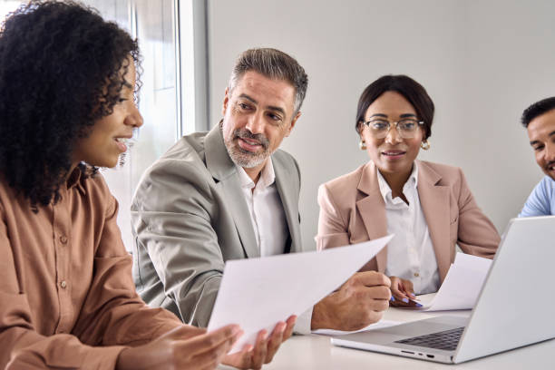 istock Busy diverse business executive team working at group meeting using laptop. 2004777402