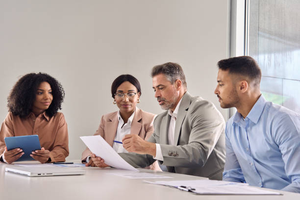 istock Senior manager consulting managing busy team working at office meeting. 2004777403