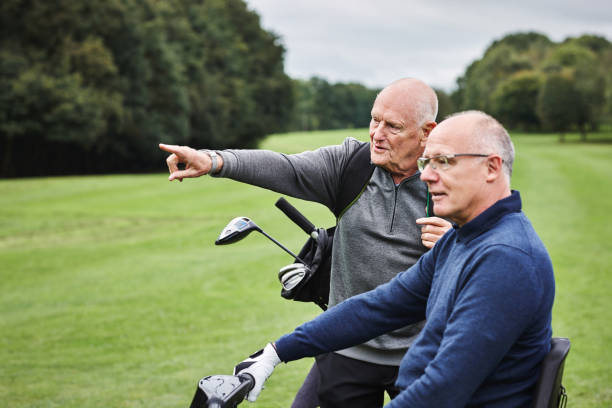 Men, golf course and pointing for sports game together for collaboration or club for coaching, competition or discussion. Male people, grass field and conversation for outdoor hobby, play or training los hombres, el campo de golf y el puntero para el juego deportivo juntos para la colaboración o el club para el entrenamiento, la competición o la discusión. personas masculinas, campo de césped y conversación para pasatiempos, juegos o entrenamiento