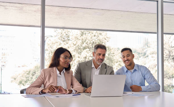 istock Three business people workers using laptop working in office at meeting. 2004777969
