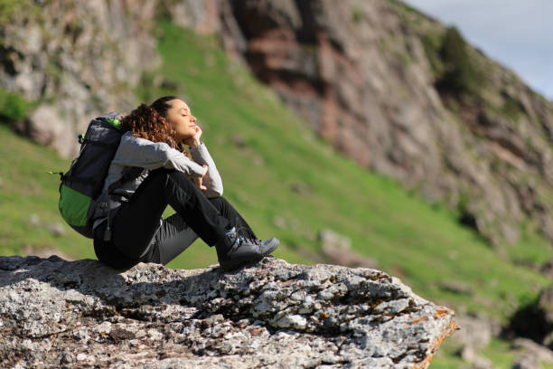 istock Hiker resting sitting in the mountain with closed eyes 2004781844