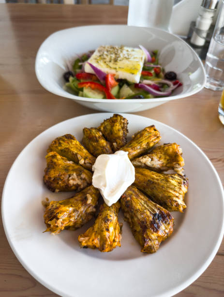 Traditional greek food: zucchini flowers stuffed with rice and greek salad.