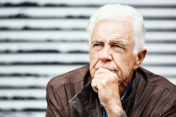 Handsome man in his 70s thinks deeply as he faces the future.
