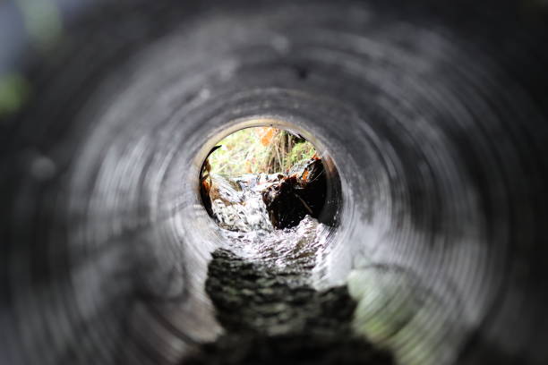istock View through a round tunnel carrying a stream beneath a road 2004833129