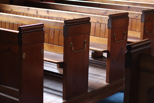 Rows of traditional wooden church pews