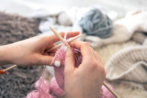 istock Close-up of hands knitting using circular needles. 2004842808