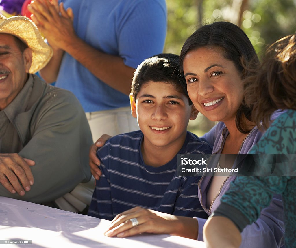 Mother and teenage son (13-15) at party in park  Latin American and Hispanic Ethnicity Stock Photo
