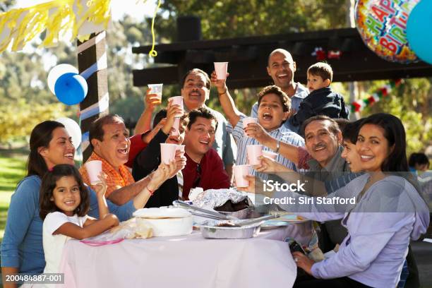 Extended Family Having Party In Park Stock Photo - Download Image Now - Birthday, Celebration, Latin American and Hispanic Ethnicity