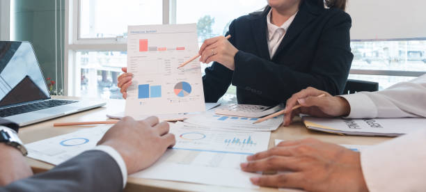 The Asian business team brainstormed and discussed work planning. Financial or statistical figures of the company in the conference room