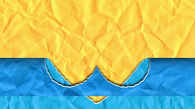 Scrap of paper in the shape of a heart in the colors of the Ukrainian flag