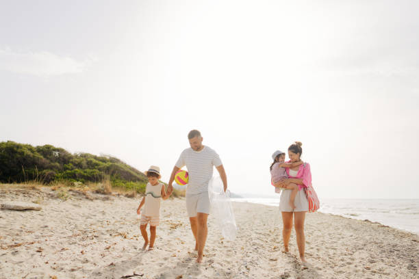 Young family walking down the beach