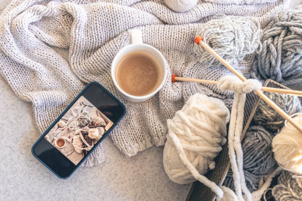 istock Yarn threads, knitted elements and a cup of coffee, top view. 2004862783