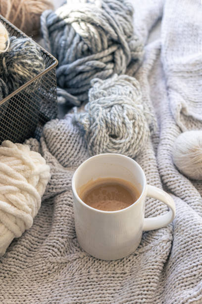 istock Close-up, cup of coffee, knitted element and yarn threads. 2004862784