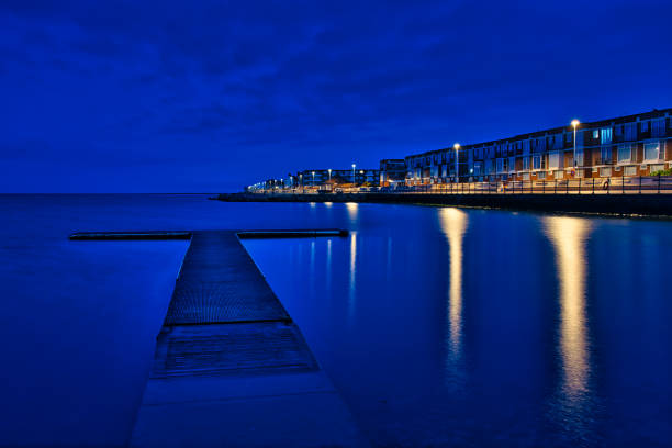 Marine lake at West Kirby during twilight with reflection of lights in water