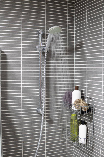 istock Open shower at home running water, restriction of water consumption and water resources. 2004876021