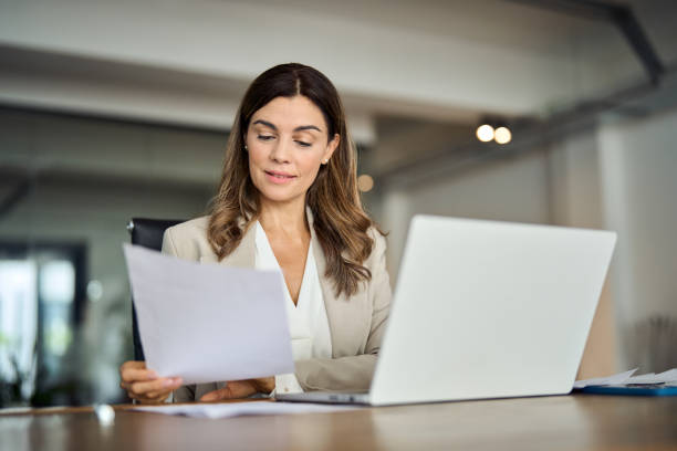 istock Busy 40 years old business woman working in office checking documents. 2004890537
