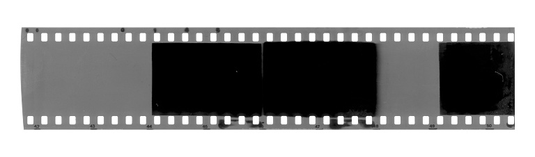 Strip of old exposed celluloid film isolated on background