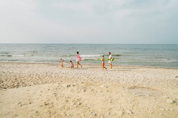 Miedzyzdroje, Poland - September 15, 2022: Colorful inflatable slide for children on sandy beach by Baltic Sea on sunny autumn day. Empty beach due to off season